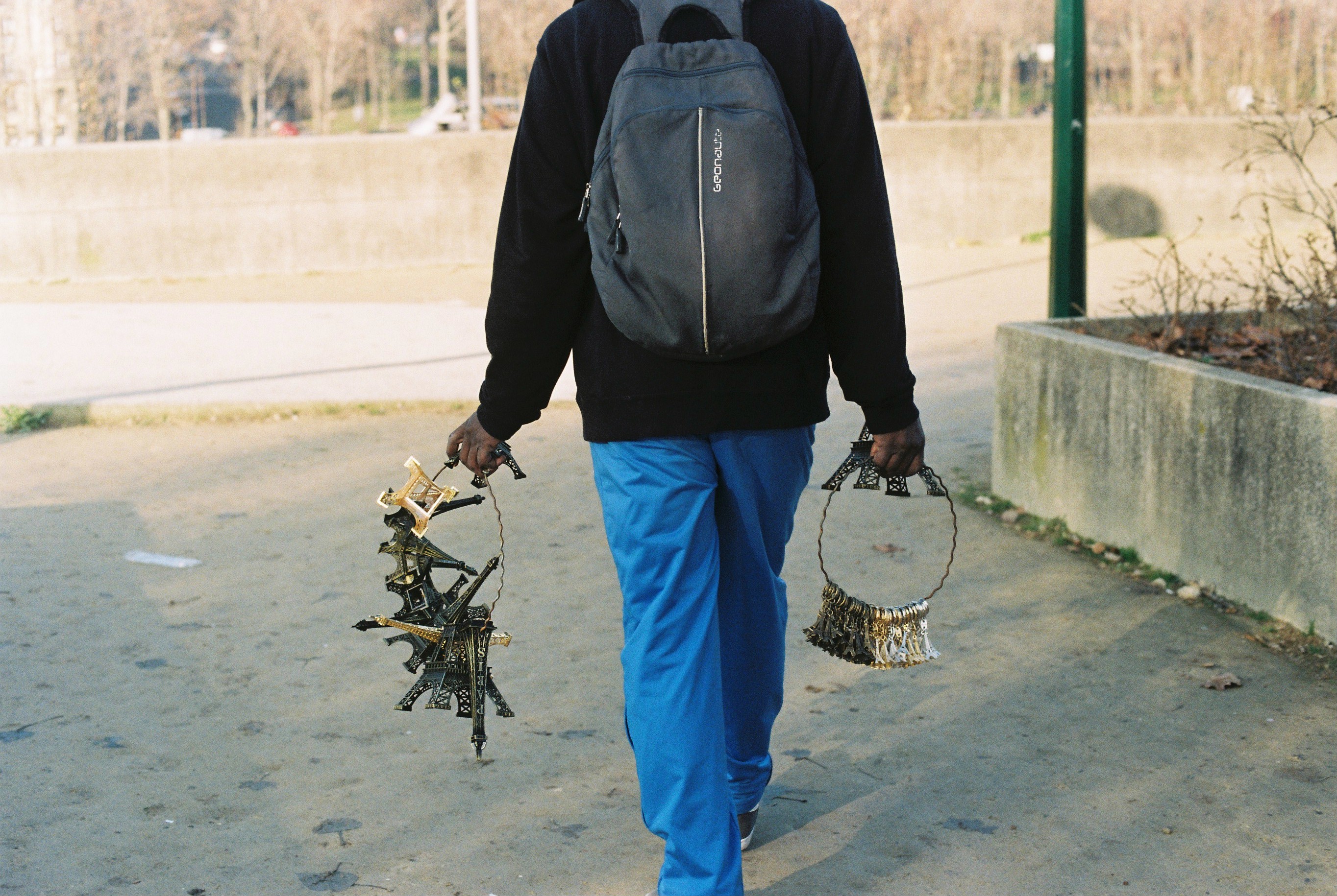 a man with blue trousers with effiel towers in his hands